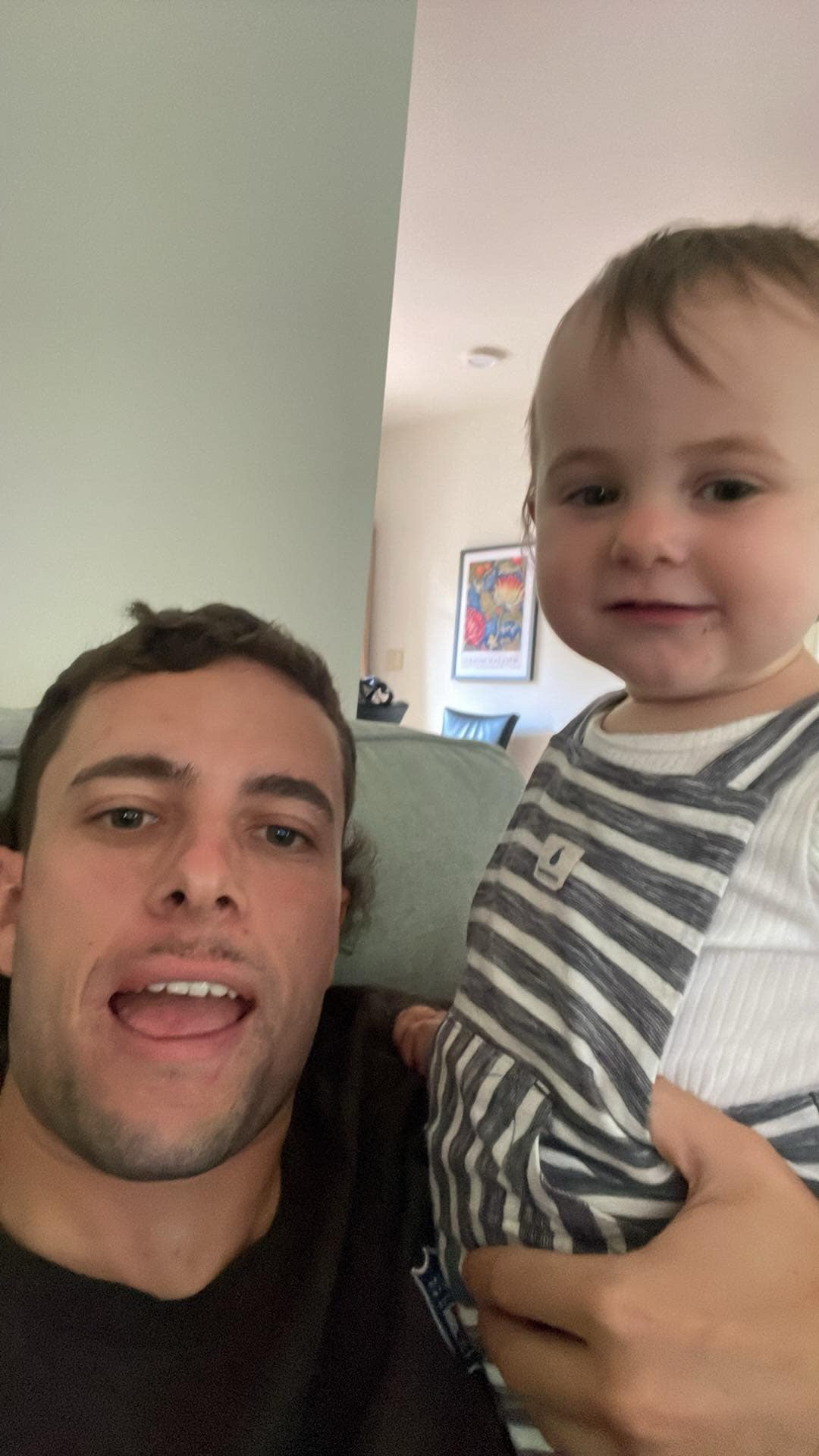 The founder of TrueHost at home, holding his young child